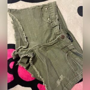 Green ripped shorts